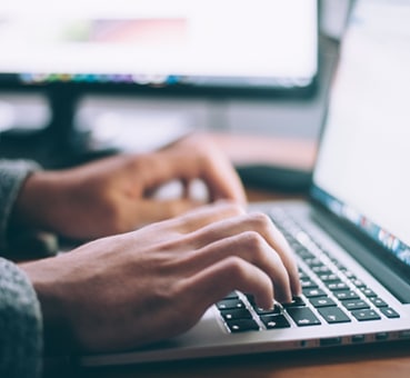 man on his laptop looking for an online counselling course hands of a man on his laptop looking for an e-therapy course