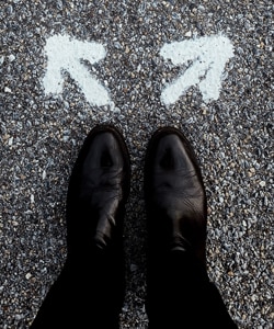 Referrals in Counselling - top view image of a man's shoes with two arrows drawn in chalk on the ground Referrals in Counselling - top view image of a man's shoes with two arrows drawn in chalk on the ground
