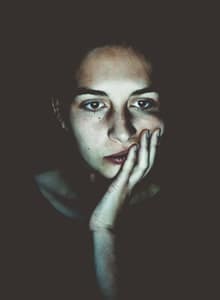 woman's face illuminated by light from her laptop screen Black-Hole Effect in Online Counselling - woman's face illuminated by light from her laptop screen